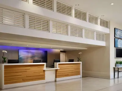 an office lobby with a large wall of windows at Sonesta Redondo Beach and Marina in Redondo Beach