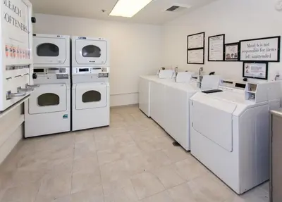 a laundry room with white washers and dryers at Motel 6-Los Angeles, CA - Los Angeles - LAX in Inglewood