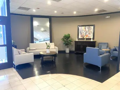 a lobby with couches and chairs and a table at Ramada by Wyndham Los Angeles/Wilshire Center in Los Angeles