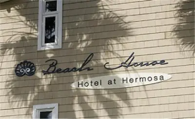 a shadow of a woman on the side of a house at Beach House Hotel at Hermosa Beach in Hermosa Beach