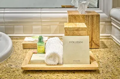 a bathroom counter with towels and a box on it at Beach House Hotel at Hermosa Beach in Hermosa Beach
