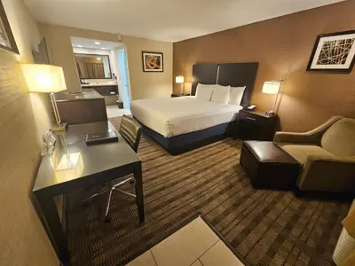 a hotel room with a bed and a desk at Best Western Pasadena Royale Inn & Suites in Pasadena