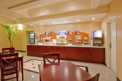 a fast food restaurant with a table and chairs at Holiday Inn Express Hotel & Suites Los Angeles Airport Hawthorne by IHG in Hawthorne