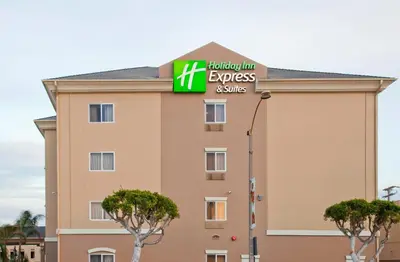 a hotel with a sign for the hilton express and suites at Holiday Inn Express Hotel & Suites Los Angeles Airport Hawthorne by IHG in Hawthorne