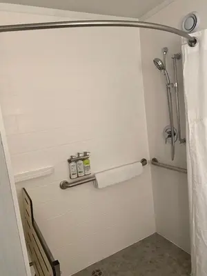 a bathroom with a shower stall with two towels at Holiday Inn Express Hotel & Suites Hermosa Beach by IHG in Hermosa Beach