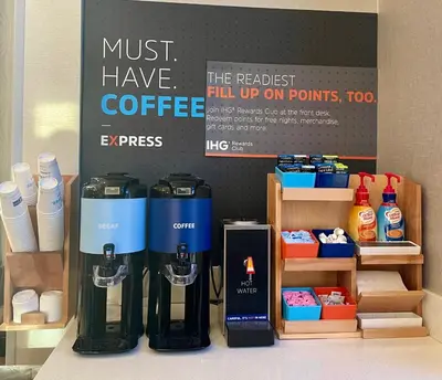 a coffee shop with a bunch of coffee machines at Holiday Inn Express Hotel & Suites Hermosa Beach by IHG in Hermosa Beach