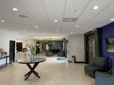 an office lobby with a table and chairs at Holiday Inn Express Hotel & Suites Hermosa Beach by IHG in Hermosa Beach
