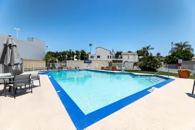 a swimming pool with a table and chairs at Holiday Inn Express Van Nuys by IHG in Van Nuys