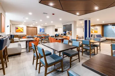 a dining room with tables and chairs at Holiday Inn Express Van Nuys by IHG in Van Nuys