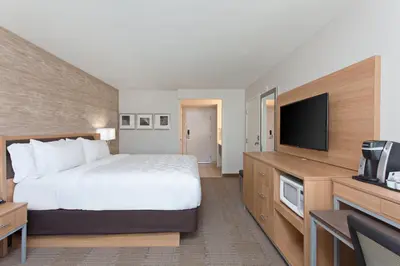 a hotel room with a bed and a flat screen tv at Holiday Inn Palmdale-Lancaster by IHG in Palmdale