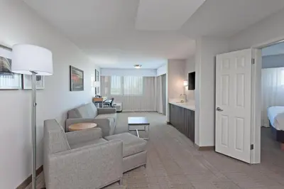 a hotel room with a couch and a bed at Holiday Inn Palmdale-Lancaster by IHG in Palmdale