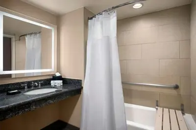 a bathroom with a sink and a shower curtain at Crowne Plaza Hotel Los Angeles Harbor by IHG in San Pedro