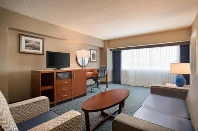 a hotel room with a television and a living room at Crowne Plaza Hotel Los Angeles Harbor by IHG in San Pedro