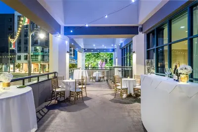 a restaurant with tables and chairs in a building at Crowne Plaza Hotel Los Angeles Harbor by IHG in San Pedro