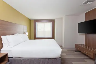 a hotel room with a bed and a flat screen tv at Holiday Inn Express & Suites Pasadena - Los Angeles by IHG in Pasadena