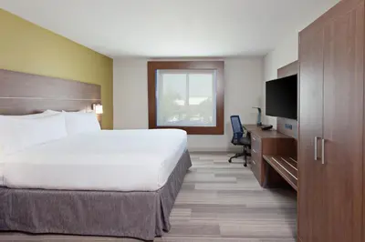 a hotel room with a large bed and a television at Holiday Inn Express & Suites Pasadena - Los Angeles by IHG in Pasadena
