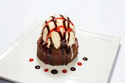 a chocolate cake with ice cream on a plate at DoubleTree by Hilton Carson in Carson