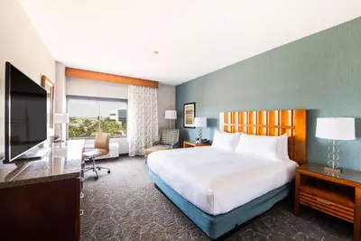a hotel room with a bed and a television at DoubleTree by Hilton Carson in Carson