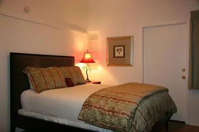 a bedroom with a bed with a lamp next to it at Ojai Retreat & Inn in Ojai