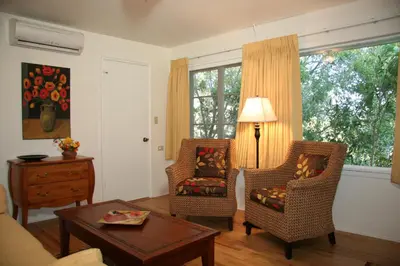 a living room with two chairs and a table at Ojai Retreat & Inn in Ojai