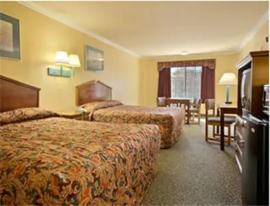 a hotel room with two beds and a living room at Super 8 by Wyndham Los Angeles Downtown in Los Angeles