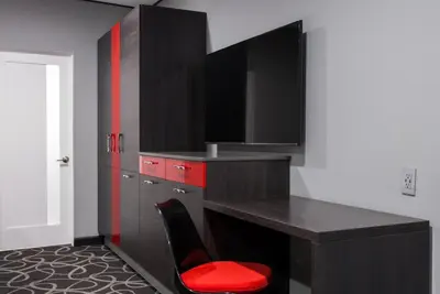 a kitchen with a desk and a red chair at Astro Pasadena Hotel in Pasadena