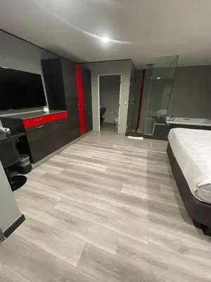 a hotel room with a bed and a flat screen tv at Astro Pasadena Hotel in Pasadena