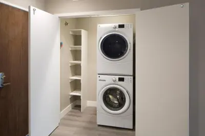 a laundry room with a washer and dryer at Hollywood Panoramic Views, Pool, Gym & Free parking! in Los Angeles