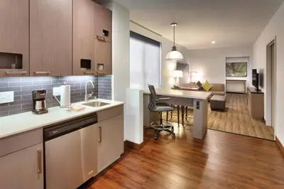 a kitchen with a desk and a dining room at Hyatt House at Anaheim Resort/Convention Center in Anaheim
