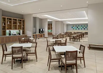 a dining room with tables and chairs and a cafeteria at Hyatt House at Anaheim Resort/Convention Center in Anaheim