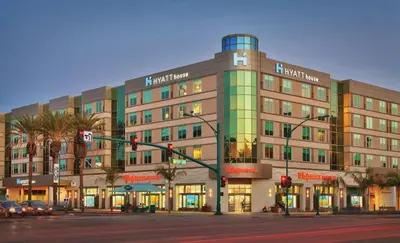 a large building on a city street with a traffic light at Hyatt House at Anaheim Resort/Convention Center in Anaheim