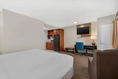 a hotel room with a bed and a desk at Comfort Inn Cockatoo Near LAX Airport in Hawthorne