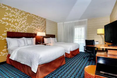 a hotel room with two beds and a desk at Fairfield Inn & Suites by Marriott Los Angeles Rosemead in Rosemead