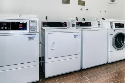 a group of white washers and dryers in a room at Fairfield Inn & Suites by Marriott Los Angeles Rosemead in Rosemead