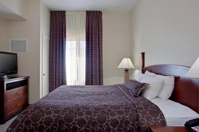a hotel room with a bed and a television at Staybridge Suites Palmdale by IHG in Palmdale