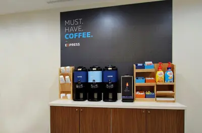 a counter with bottles of coffee on it at Holiday Inn Express Bakersfield by IHG in Bakersfield