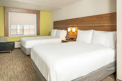 a hotel room with two beds and a window at Holiday Inn Express Hotel & Suites Hesperia by IHG in Hesperia