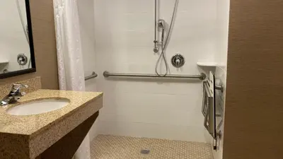 a bathroom with a sink and a shower at Holiday Inn & Suites Bakersfield by IHG in Bakersfield