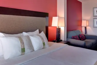 a hotel room with a bed and a couch at Holiday Inn & Suites Bakersfield by IHG in Bakersfield