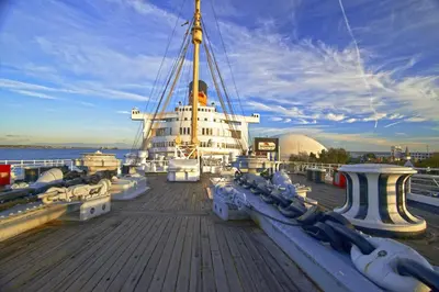 a large boat sitting on top of the water at The Queen Mary in Long Beach