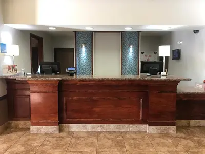 a lobby with a large wooden bar in a hotel at Holiday Inn Express & Suites Barstow - Route 66 by IHG in Barstow