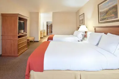 a hotel room with two beds and a television at Holiday Inn Express & Suites Barstow - Route 66 by IHG in Barstow
