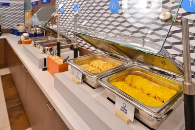 a buffet line with trays of food on display at Holiday Inn Express & Suites Barstow - Route 66 by IHG in Barstow