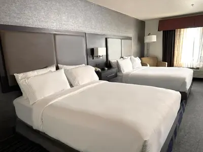 two beds in a hotel room with white pillows at Holiday Inn Express & Suites Barstow - Route 66 by IHG in Barstow