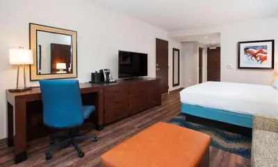 a hotel room with a bed and a desk and a chair at Hilton Garden Inn Burbank Los Angeles in Burbank