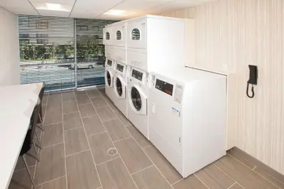 a laundry room with two washer and dryer at Hilton Garden Inn Burbank Los Angeles in Burbank