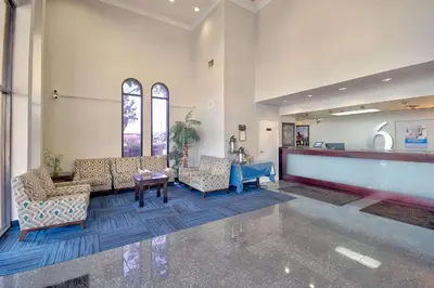 a lobby with two chairs and a table in a building at Studio 6 Suites Lawndale, CA South Bay in Lawndale