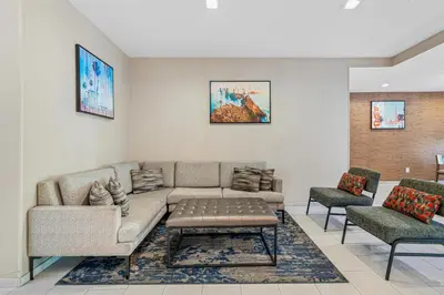 a living room with a couch and two chairs at Best Western Valencia/Six Flags Inn & Suites in Santa Clarita