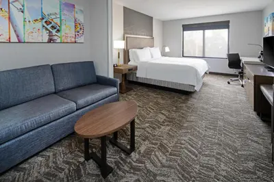 a hotel room with a couch and a bed at Best Western Valencia/Six Flags Inn & Suites in Santa Clarita