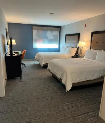 a hotel room with two beds and a television at Holiday Inn Express San Bernardino Colton by IHG in Colton